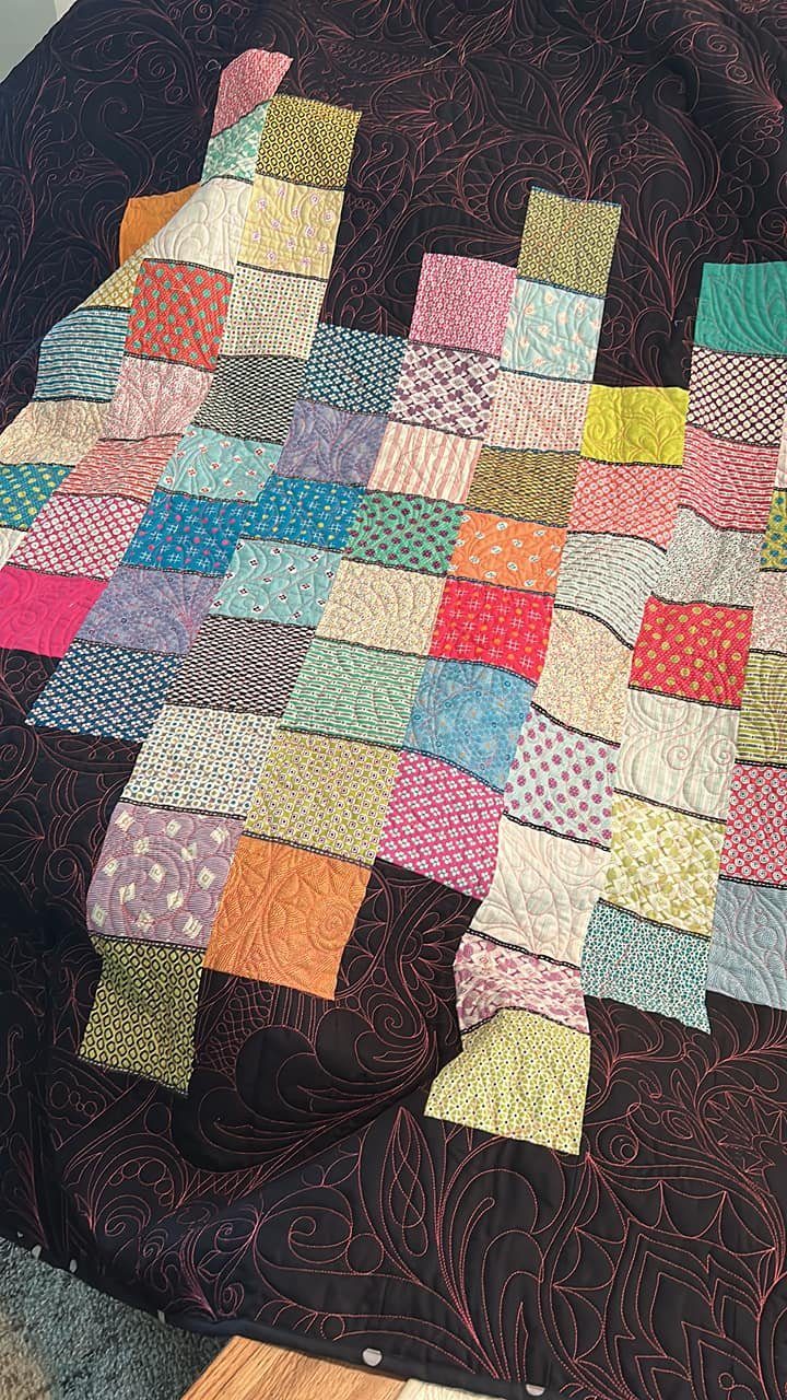 Colorful patchwork quilt with swirling machine quilting